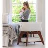 TruBliss Evi Smart Baby Bassinet Beside Sleeper with Auto-Glide, Ambient Nightlight & Sensory Sounds, Compatible with Alexa and Google Home, Includes 2 Sheets (Soft White w/Espresso Legs) view 3