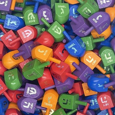 The Dreidel Company 100-Pack Wood Multi-Colored Dreidels Medium Sized Hanukkah Draydels with Foil Embossed English Transliteration